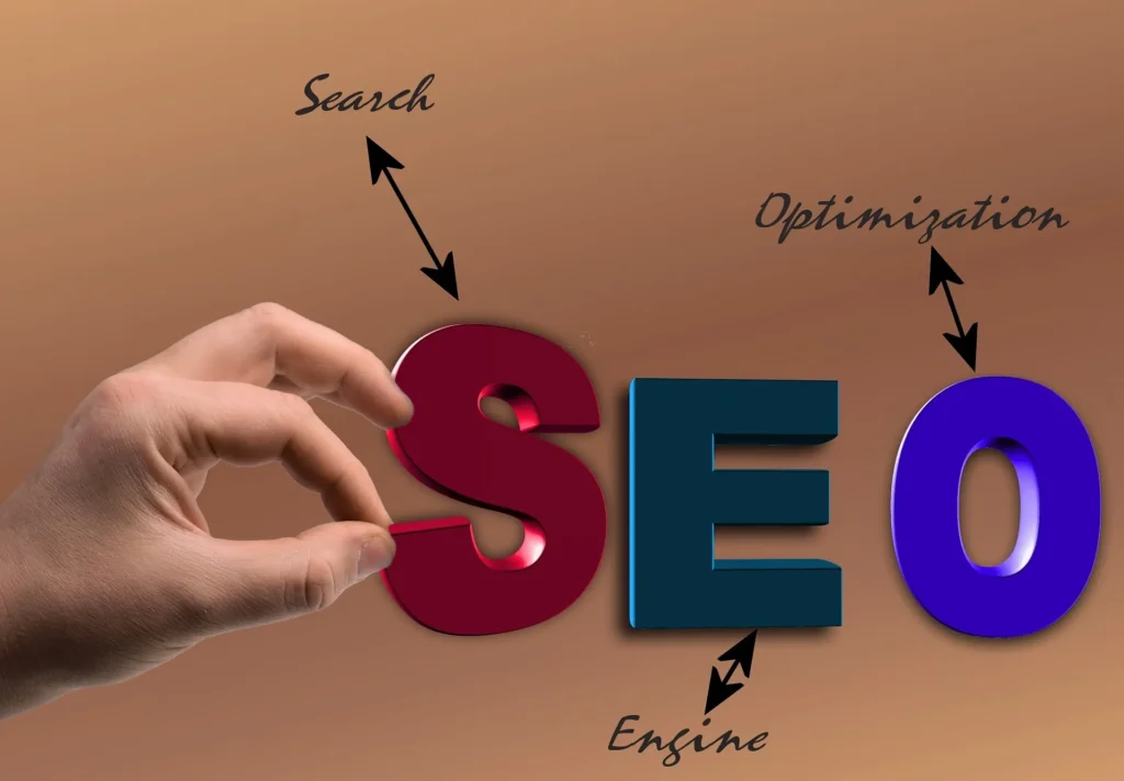 A hand placing the letter 'S' to complete a large 3D "SEO" acronym. Arrows point from the letters to the words "Search," "Engine," and "Optimization" written in elegant cursive.